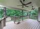 Covered deck with two ceiling fans overlooks a wooded backyard, enhancing the outdoor living experience of this home at 414 Candler Trl, Canton, GA 30115