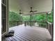 Spacious covered deck featuring two ceiling fans and wooded views, perfect for relaxing and entertaining outdoors at 414 Candler Trl, Canton, GA 30115