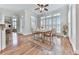Sunlit dining room features hardwood floors, a glass top table, and large windows with plantation shutters at 414 Candler Trl, Canton, GA 30115