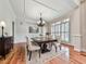 Elegant dining room with hardwood floors, chandelier, and large windows with plantation shutters at 414 Candler Trl, Canton, GA 30115