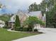Charming two-story home with brick and stone facade, lush landscaping, and a welcoming front porch at 414 Candler Trl, Canton, GA 30115