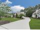 Traditional two-story home boasts a well-manicured lawn, mature trees, and long driveway leading to attached garage at 414 Candler Trl, Canton, GA 30115