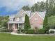 Elegant two-story home with well-maintained lawn, brick and stone accents, and meticulously manicured landscaping at 414 Candler Trl, Canton, GA 30115