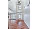 Grand foyer showcases hardwood floors, a soaring ceiling, and an elegant chandelier creating a dramatic entrance at 414 Candler Trl, Canton, GA 30115
