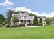 Beautiful two-story home with brick and stone exterior, featuring a well-maintained front lawn and landscaping at 414 Candler Trl, Canton, GA 30115