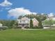 Charming two-story brick home with a manicured lawn, mature trees, and a welcoming front porch at 414 Candler Trl, Canton, GA 30115