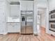 Kitchen featuring stainless steel appliances and sleek white cabinetry at 414 Candler Trl, Canton, GA 30115