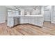 Kitchen island with stainless steel dishwasher, white cabinets, and granite countertop at 414 Candler Trl, Canton, GA 30115