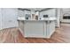 Kitchen island with elegant detailing, hardwood floors, and ample cabinet space at 414 Candler Trl, Canton, GA 30115