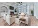 Cozy living room with hardwood floors, a fireplace, and built-in shelving and cabinetry at 414 Candler Trl, Canton, GA 30115