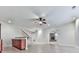 Open living area with a granite bar, staircase, and a stone fireplace in the background at 414 Candler Trl, Canton, GA 30115
