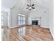 Spacious living room features a fireplace, hardwood floors, large windows, and vaulted ceilings at 414 Candler Trl, Canton, GA 30115