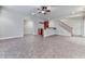Spacious living room with a bar area, tile flooring, and staircase access at 414 Candler Trl, Canton, GA 30115