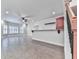 Open-concept living room with a built-in bar, tile floors, and ample natural light at 414 Candler Trl, Canton, GA 30115