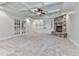 Cozy living room with built-in shelving, a stone fireplace, and french doors at 414 Candler Trl, Canton, GA 30115
