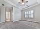 Bright main bedroom featuring tray ceilings, neutral paint and carpet, and plantation shutters at 414 Candler Trl, Canton, GA 30115