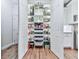 Organized pantry with white shelving, drawers, lighting, and a variety of storage containers and food items at 414 Candler Trl, Canton, GA 30115