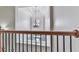 Elegant staircase with wrought iron railings and a decorative chandelier in the foyer at 414 Candler Trl, Canton, GA 30115