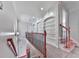 Upstairs hallway featuring built-in shelves and a staircase with wood and wrought iron railings at 414 Candler Trl, Canton, GA 30115