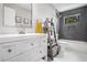 Bathroom featuring a vintage-style vanity with shiplap doors, modern fixtures, and stylish gray tile at 4469 Huntington Cir, Atlanta, GA 30338