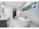 Modern bathroom featuring a soaking tub, dual vanity, and stylish fixtures at 4469 Huntington Cir, Atlanta, GA 30338
