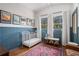 Charming bedroom featuring a crib, blue wainscoting, and bright windows at 4469 Huntington Cir, Atlanta, GA 30338