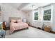 Cozy bedroom with floral wallpaper, plush rug, and bright windows at 4469 Huntington Cir, Atlanta, GA 30338