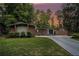 Charming brick home featuring a well-manicured lawn and a long driveway in a serene, wooded setting at 4469 Huntington Cir, Atlanta, GA 30338