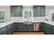 Modern kitchen featuring gray cabinets, stainless steel appliances, and bright marble countertops at 4469 Huntington Cir, Atlanta, GA 30338