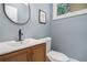 Stylish powder room featuring wood cabinet, modern sink, and elegant wall decor at 4469 Huntington Cir, Atlanta, GA 30338