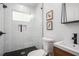 Modern tiled shower with glass door, sleek fixtures, and black floor tiles at 4469 Huntington Cir, Atlanta, GA 30338