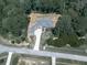 An aerial view of the home reveals its setting among mature trees and a long driveway at 106 Belmont Dr, Canton, GA 30115