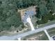 Overhead view of a modern farmhouse with a long driveway, surrounded by lush trees and greenery at 106 Belmont Dr, Canton, GA 30115