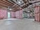 Spacious unfinished basement with pink insulation and exposed ceiling at 106 Belmont Dr, Canton, GA 30115