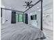 Spacious bedroom with a sleek four-poster bed, hardwood floors, and en-suite bath at 106 Belmont Dr, Canton, GA 30115