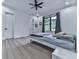 Minimalist bedroom with light wood floors, and large window view to the farm at 106 Belmont Dr, Canton, GA 30115