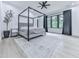 Modern bedroom with a canopy bed, large windows, and a decorative tree accent at 106 Belmont Dr, Canton, GA 30115