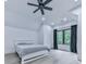 Bright bedroom with a large window, neutral walls, modern ceiling fan, and light wood floors at 106 Belmont Dr, Canton, GA 30115