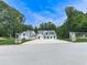 Stunning modern farmhouse with a circular driveway and lush landscaping at 106 Belmont Dr, Canton, GA 30115