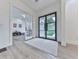 Inviting foyer with a modern black door and a view into an adjacent playroom at 106 Belmont Dr, Canton, GA 30115