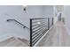 Hallway featuring modern railing, hardwood floors, and recessed lighting at 106 Belmont Dr, Canton, GA 30115