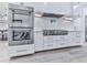 The gourmet kitchen includes stainless appliances, white cabinets, and modern lighting at 106 Belmont Dr, Canton, GA 30115