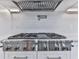Professional gas range, range hood, and pot filler faucet complete this gourmet kitchen at 106 Belmont Dr, Canton, GA 30115