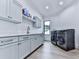 Spacious laundry room with grey cabinets, light countertops and stainless steel washer and dryer at 106 Belmont Dr, Canton, GA 30115