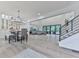Bright, open-concept living and dining area with hardwood floors, large windows, and modern chandelier lighting at 106 Belmont Dr, Canton, GA 30115