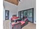Covered patio with vaulted wood ceiling, fireplace, and comfortable seating for outdoor enjoyment at 106 Belmont Dr, Canton, GA 30115