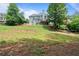 Large backyard featuring a sprawling lawn and home's rear elevation at 1758 Rosehedge Nw Way, Kennesaw, GA 30152
