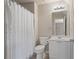 Bathroom with white decorative shower curtain, neutral paint and modern vanity at 1758 Rosehedge Nw Way, Kennesaw, GA 30152