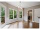 Bright breakfast nook boasts hardwood floors, a modern light fixture, and a view to the outdoors at 1758 Rosehedge Nw Way, Kennesaw, GA 30152
