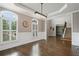 Dining room featuring wainscoting, hardwood floors, a tray ceiling, and plantation shutters at 1758 Rosehedge Nw Way, Kennesaw, GA 30152